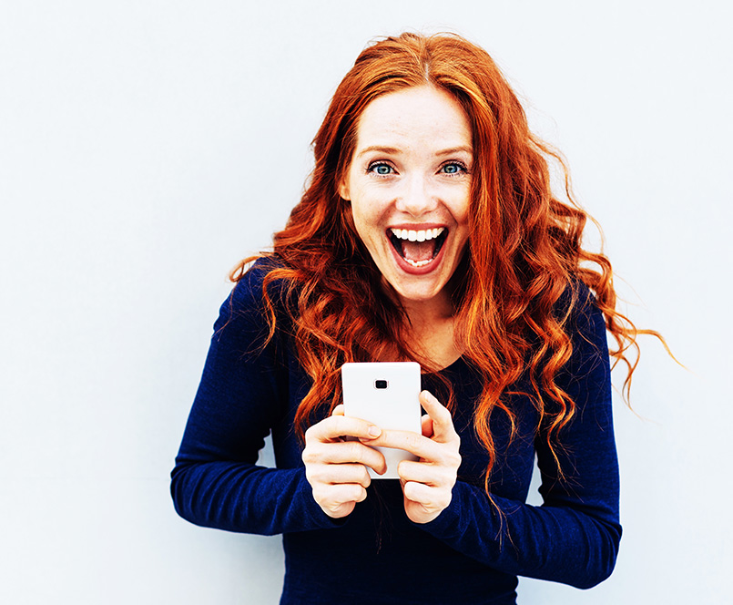 Excited woman holding phone