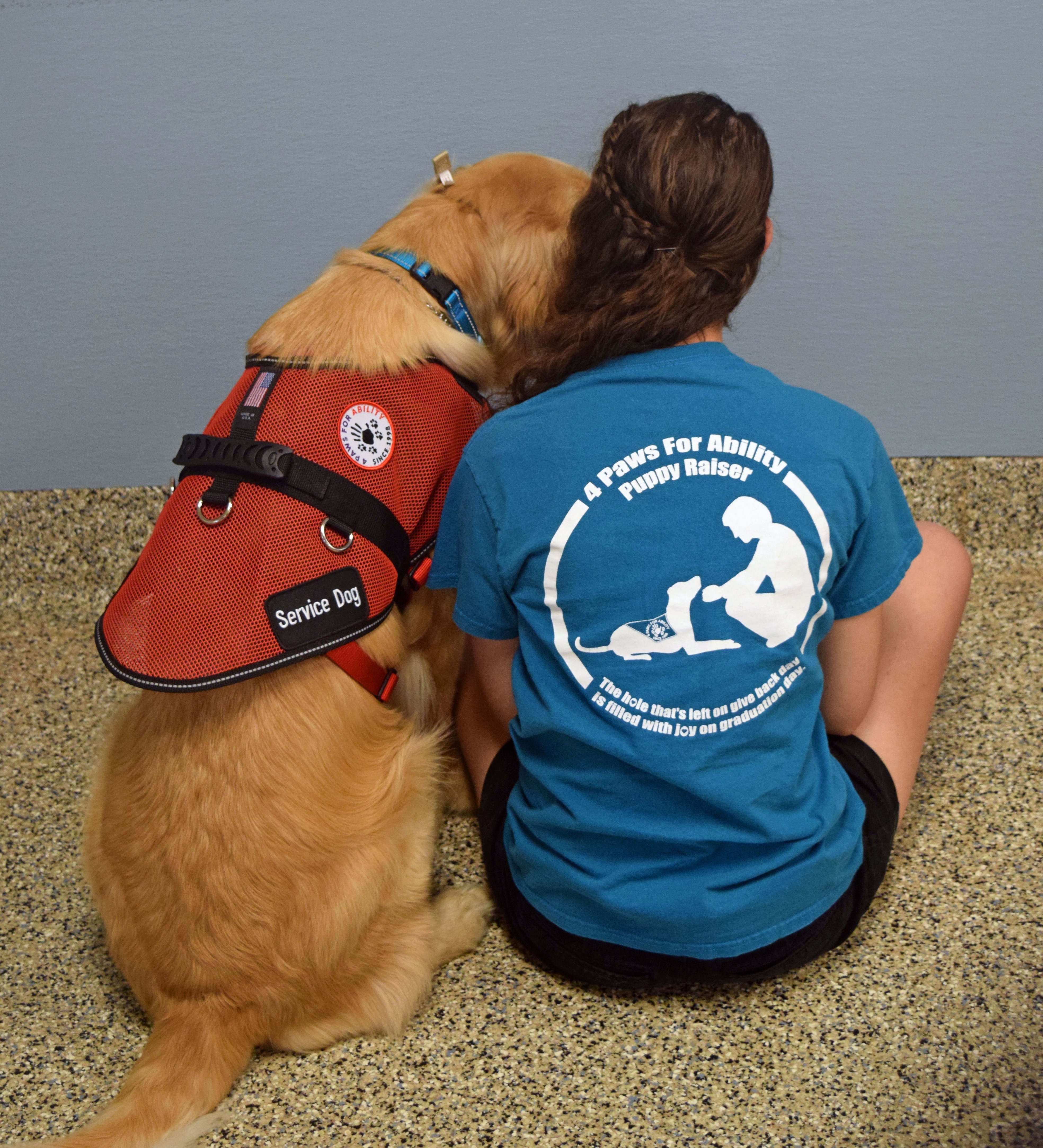 Young lady sitting with a service dog