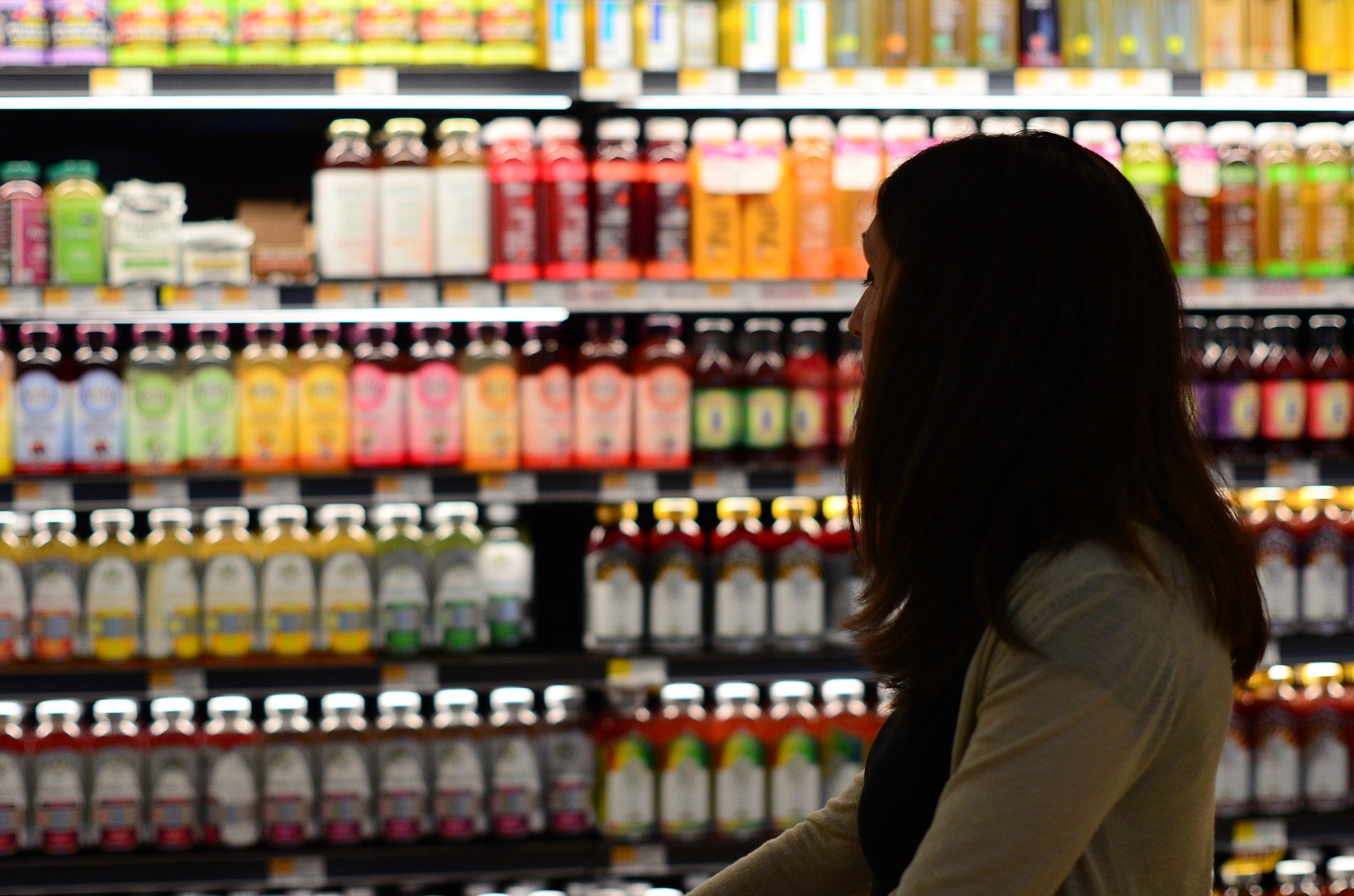 Image of woman looking at juice in the grocery store